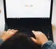 person using black laptop computer