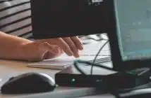 person using computer on table