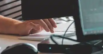 person using computer on table